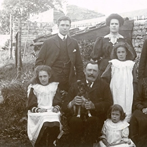 Family group of ten with small dog