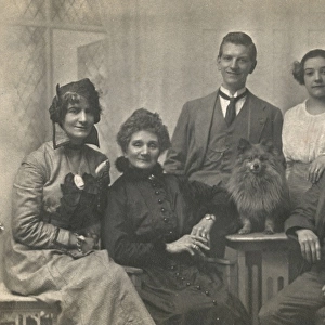 Family group studio portrait with small dog