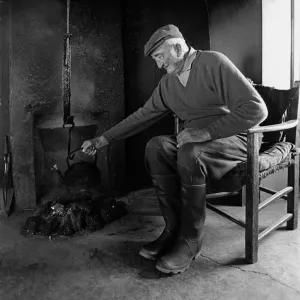 A farmer sits in the farm kitchen, Co Clare, Ireland