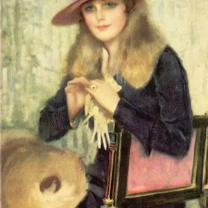 Fashionably dressed lady in hat sits waiting in a chair Date: 1910