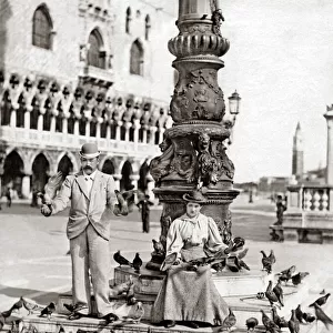 Feeding pigeons, Venice, Italy circa 1900