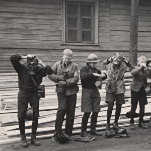 Finnish boy scouts trying on gas masks, WW2