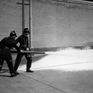 Firefighters training with foam extinguisher