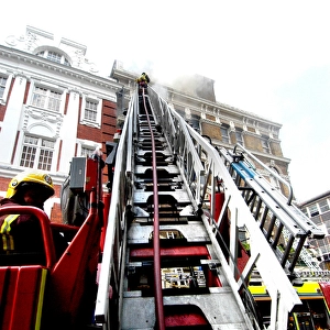 Firefighters using turntable ladder
