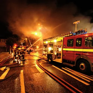 Firefighters working at scene of pub fire, SE London