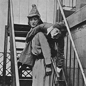 Firewomen, a rescue on an iron staircase, WW1