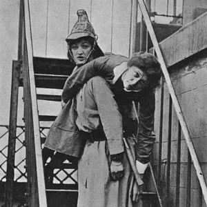 Firewomen, a rescue on an iron staircase, WW1