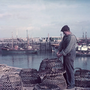 Fisherman with lobster pots, Brixham Harbour, Devon