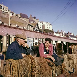 Two fishermen in Brixham Harbour, Devon