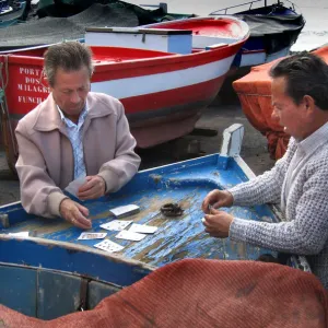 Fishermen play cards on a fishing boat at Funchal Fishermen play cards on a fishing boat at Funchal