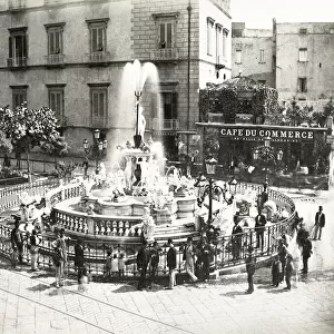 France, crowd aroud the fountain in a town square