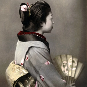 Geisha with obi sash and fan, Japan