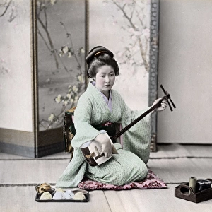 Geisha playing a samisen, Japan, circa 1890