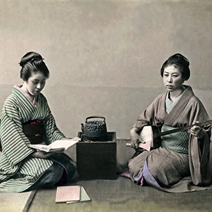 Two geishas, stove and shamisen, Japan