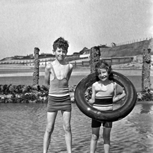 Girl and boy paddling at the seaside
