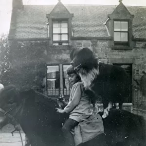 Girl with pet dog on horseback, 1920s
