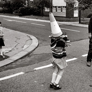 Girl with traffic cone on her head