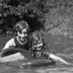 Two girls bathing in a stream