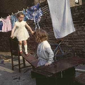 Two girls playing with planks, Balham, SW London