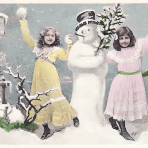 Two girls with snowman on a Christmas postcard