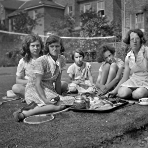 Five girls with tea tray in a garden