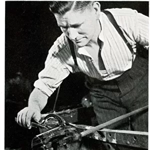 Glass blower fixing a handle on a jug