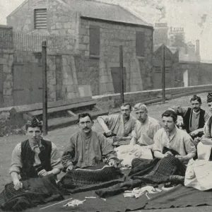 Gordon Highlanders making kilts in the open air