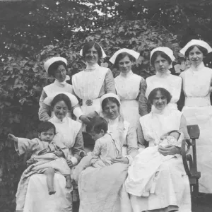 Group of nurses and children outdoors Group of nurses and children outdoors
