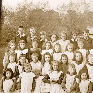 Group photo of children, the girls wearing smocks