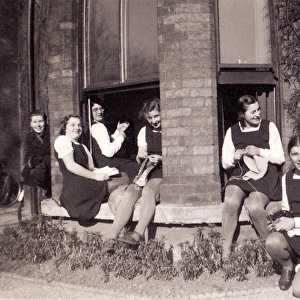 Group sitting at open bay window