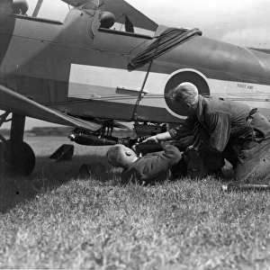 A de Havilland DH82A Tiger Moth is bombed-up at Hatfield