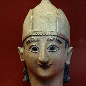 Head from a statue of a warrior with conical helmet. 625-600