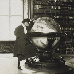 Helen Johns Kirtland leaning on a globe