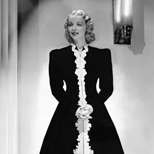 A hostess gown of black velvet, designed by Dolly Tree