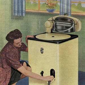 Housewife with her new Ritemp electric washing machine
