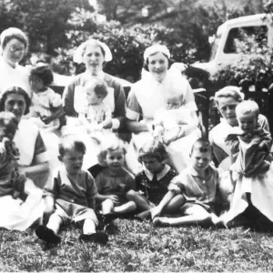 Informal outdoor group of nurses and children Informal outdoor group of nurses and children