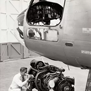Inspecting engine beside Belvedere helicopter