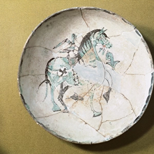 Islamic pottery. Taifor. Plate decorated with horse. Ceramic