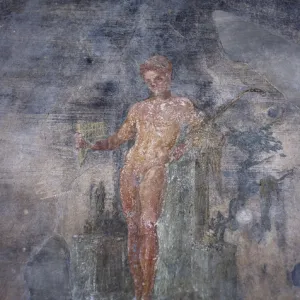 Italy. Pompeii. House of the Vettii. Young man playing the f