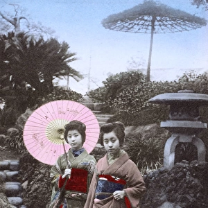 Japan - Two Geisha Girls - pose in an ornamental garden