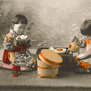 Japan - Two young Children eating rice and drinking tea