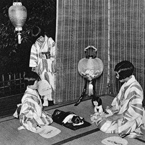 Japanese children putting their dolls to bed on a hot night