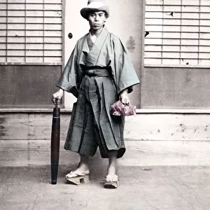 Japanese man in outdoor shoes and with umbrella, Japan