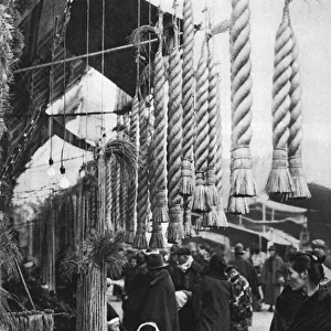 A Japanese man sells straw ropes at a market