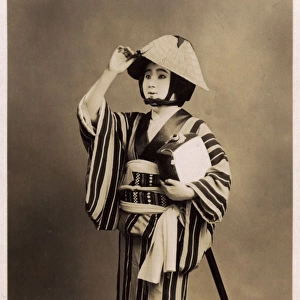 Japanese theatrical performer holding a Shamisen