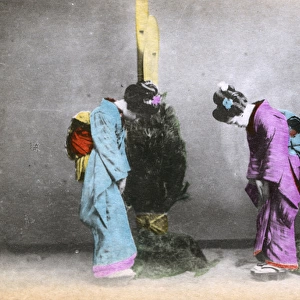 Two Japanese women greet each other with a bow