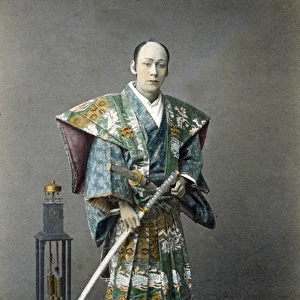 Japense samurai (actor) with a clock, Japan, circa 1880s