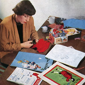 Joan Jordan creating The Tatler Xmas number cover, 1950