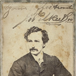 John Wilkes Booth, half-length studio portrait, sitting