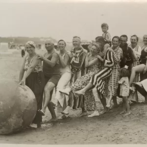 A very jolly group playing with a huge ball on the beach